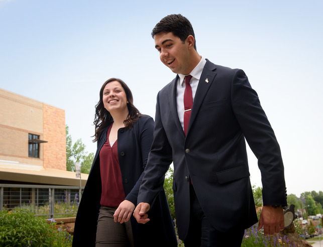 Two students walk in suits