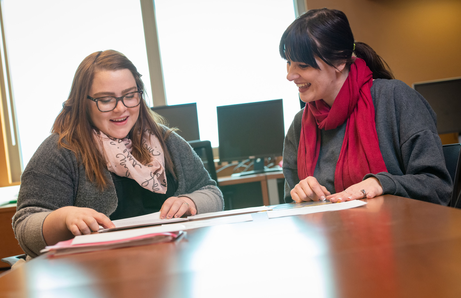 Two people working at a desk together