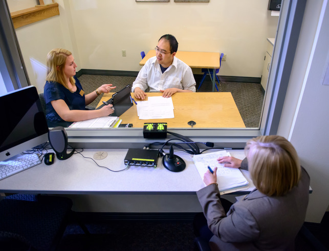 Student watches two people in a clinical observation setting
