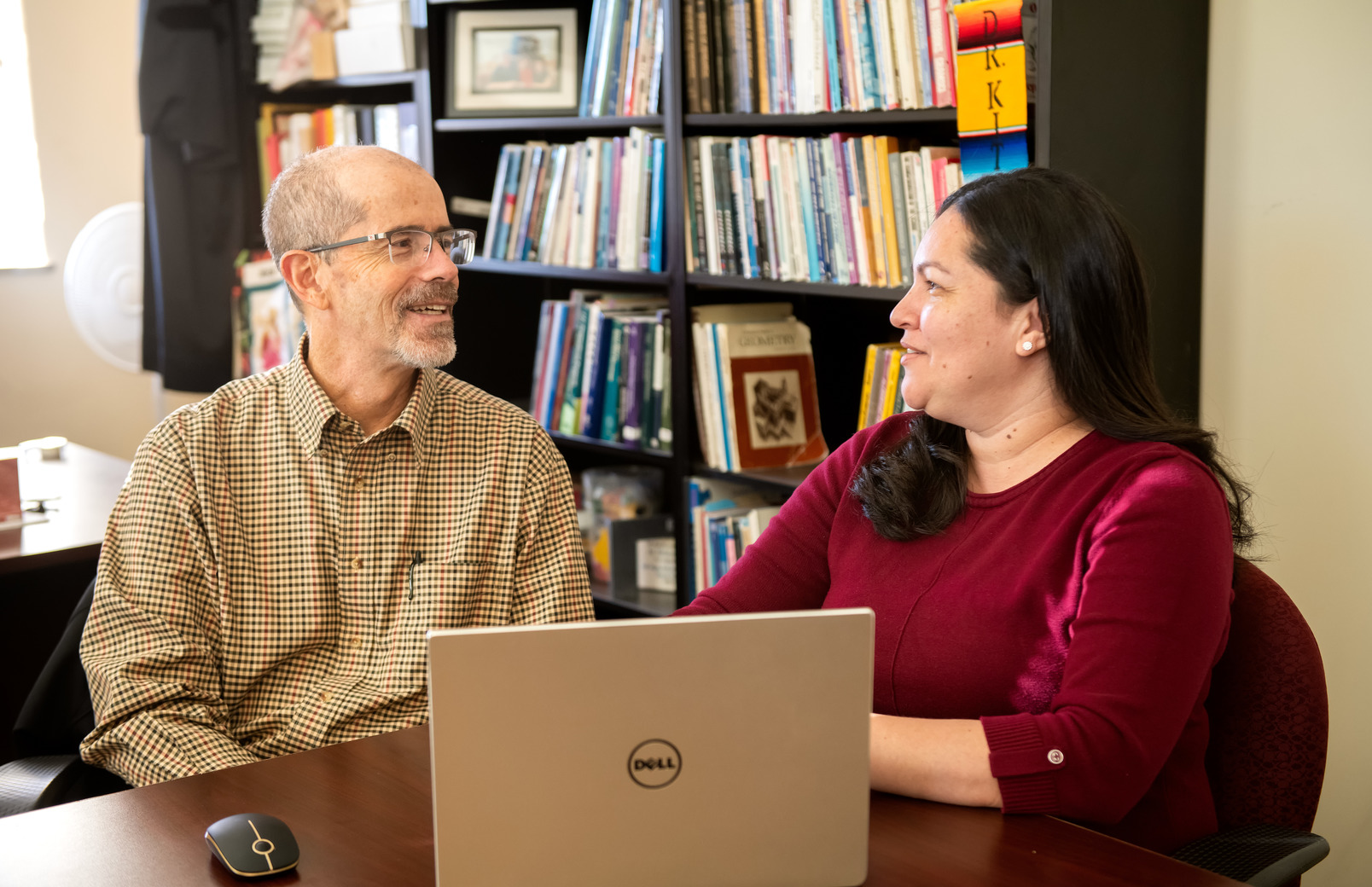 Two colleagues working together on a laptop