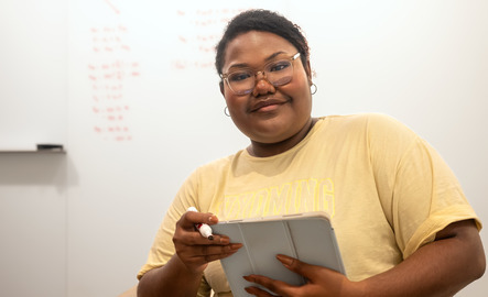 Student holds a tablet
