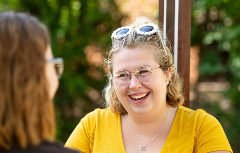 A student smiles at a friend