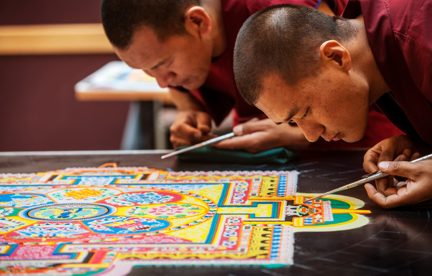 Tibetan Monks creating a mandala sand painting in the Student Union
