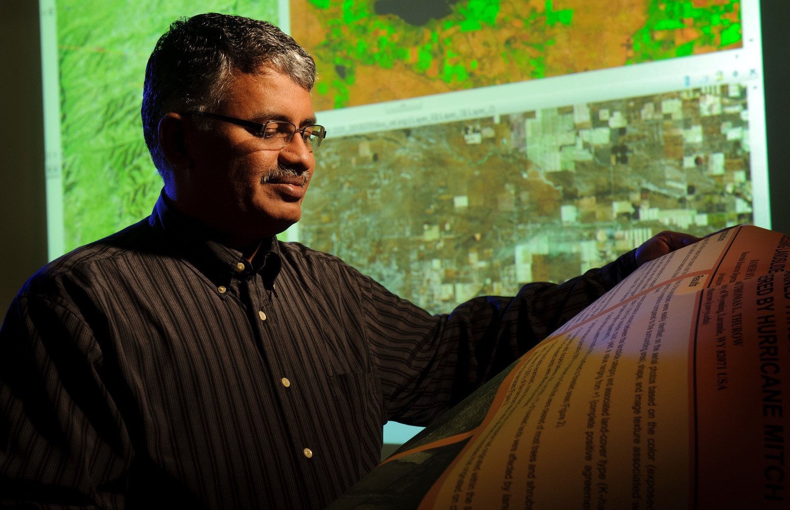 Person looks at illuminated map