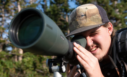 Student looking through a camera lens