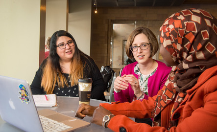 Three students work at a cafe