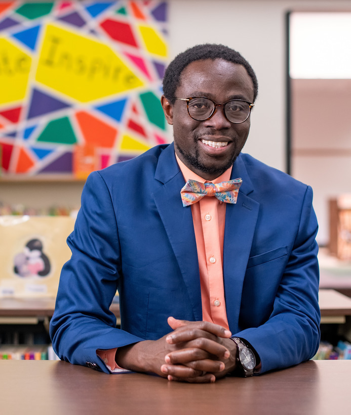 School principal sitting in a classroom