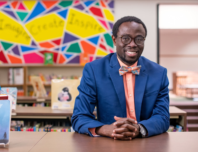 School principal sitting in a classroom