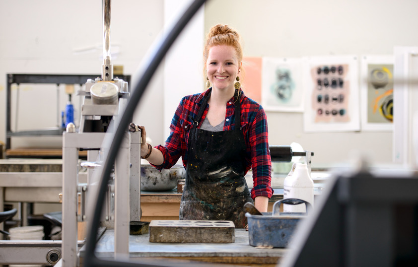 Student in art studio smiling for a picture