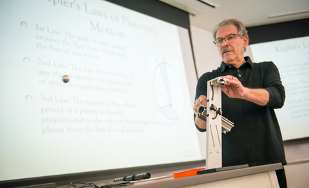 A professor does an experiment at the front of the class