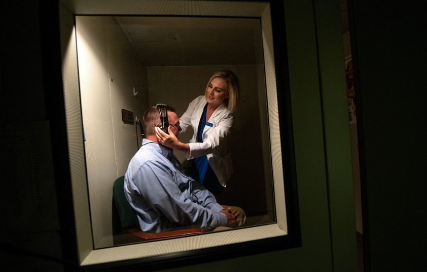 Audiologist working with client