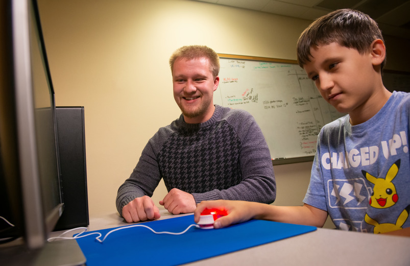 A graduate student works with a child in the Speech and Hearing Clinic