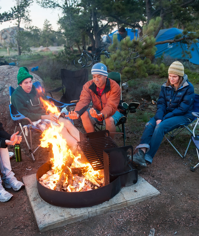 People sit around a campfire