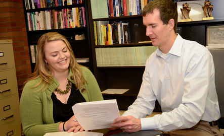 Two faculty members work together in an office