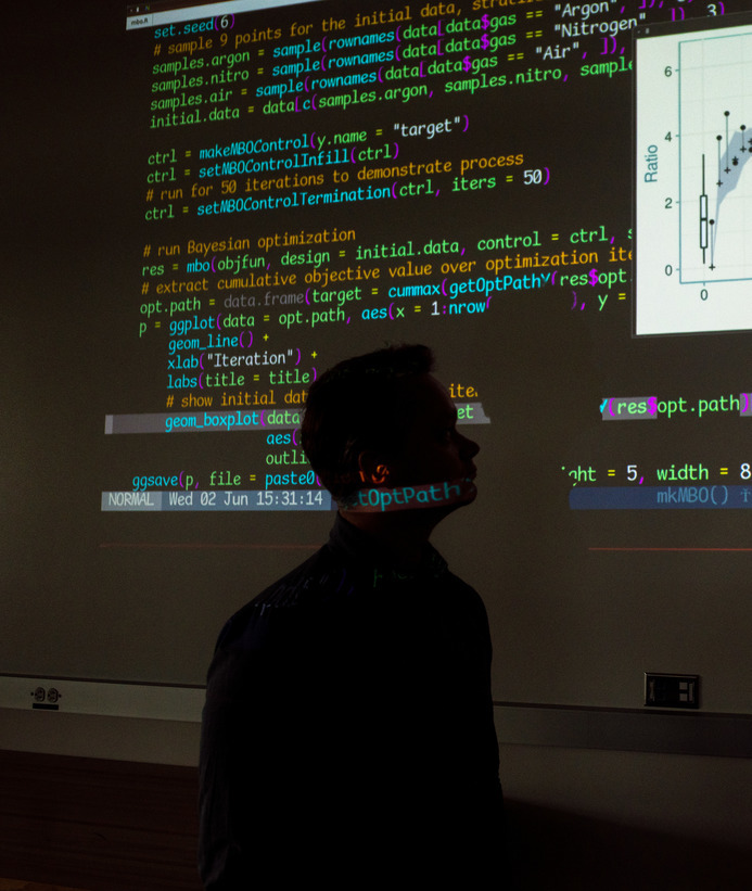 Software developer looking at code on a screen