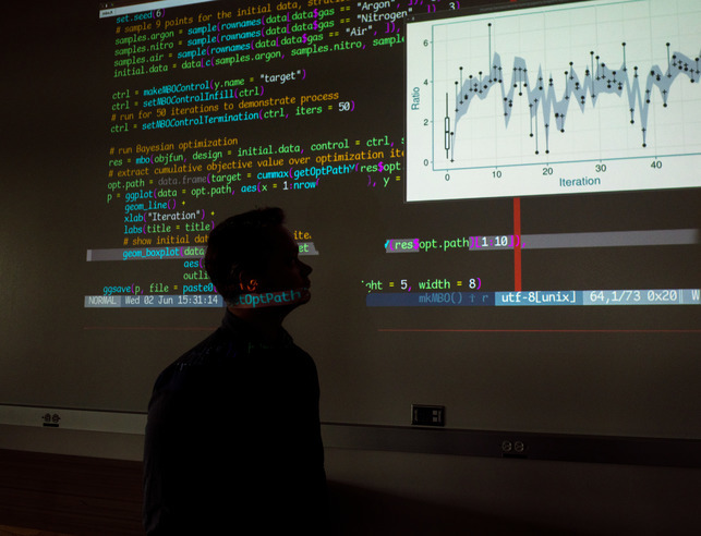 Software developer looking at code on a screen