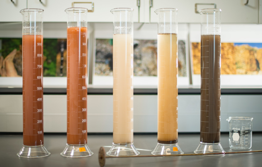 Testing tubes full of different colored soil
