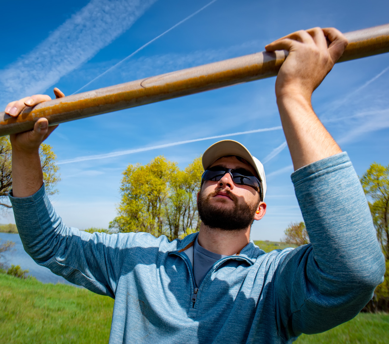 A researcher looks at a tube full of soil