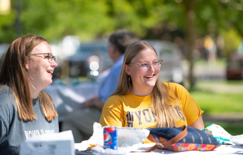 Two students smiling and talking