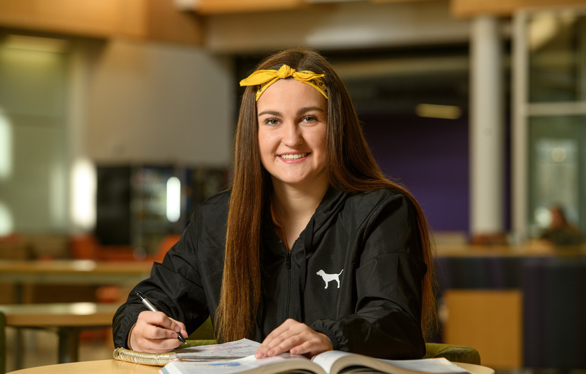 Student smiling in the library