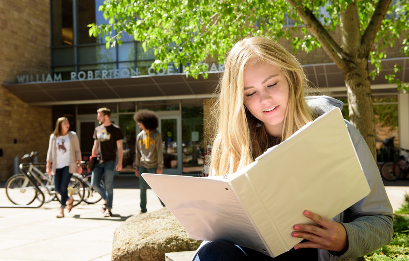 Student outside of Coe library