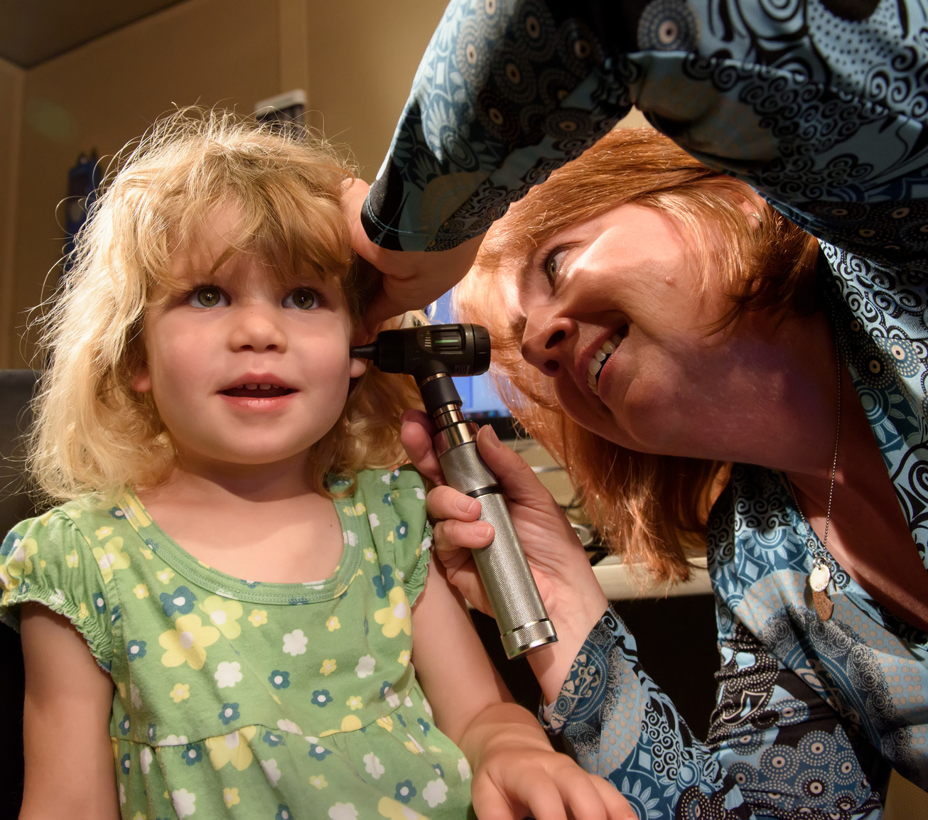 Professor examining child's ear