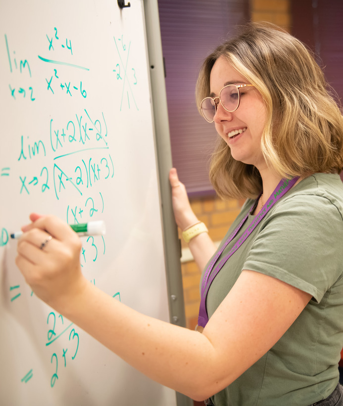 Student doing statistics on a whiteboard