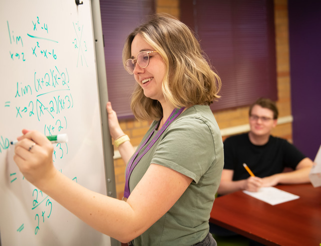 Student doing statistics on a whiteboard