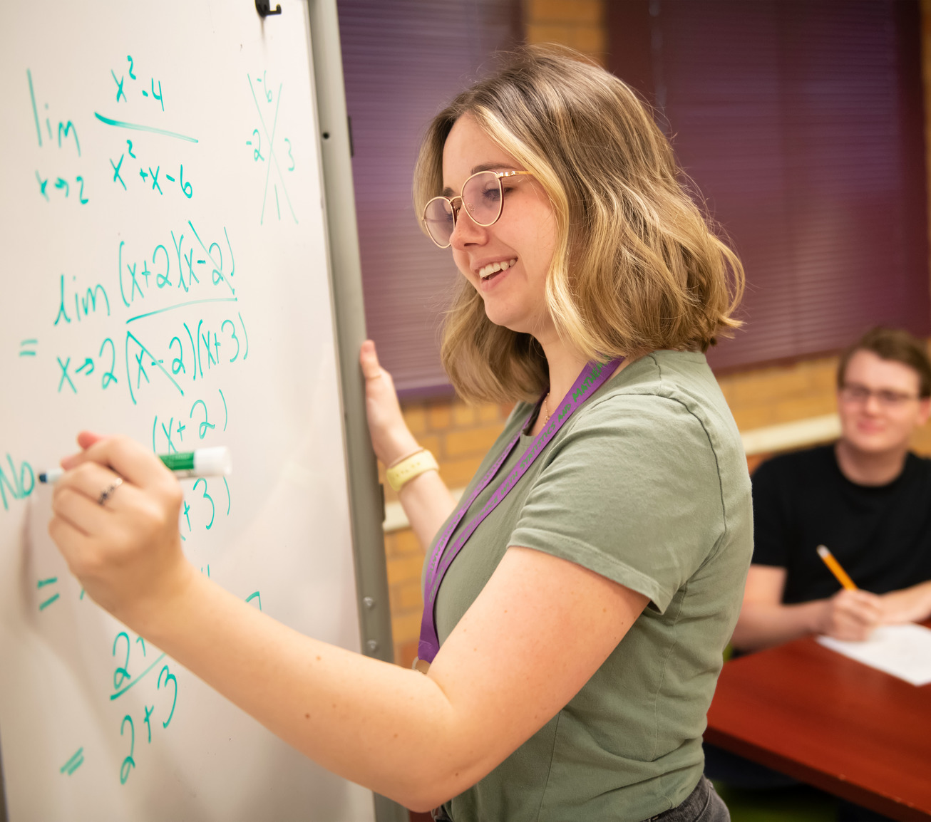 Student doing statistics on a white board