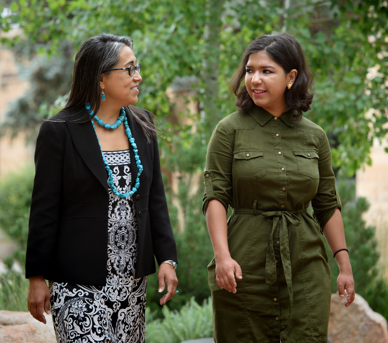 Staff and student walking on campus