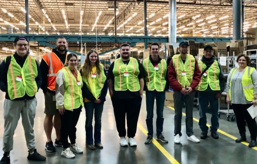 Students pose for a photo after a tour