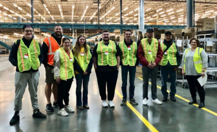 A group of supply chain students smile for a photo