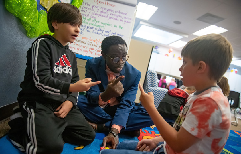 Principal working with two students