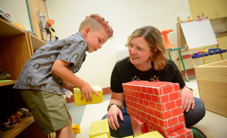 Teacher and student play with blocks