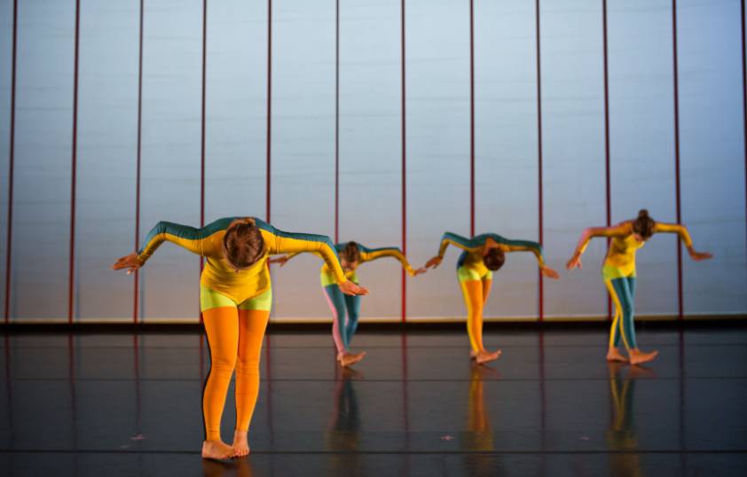 Four dancers performing on stage