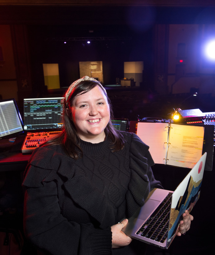 A student backstage helping with tech