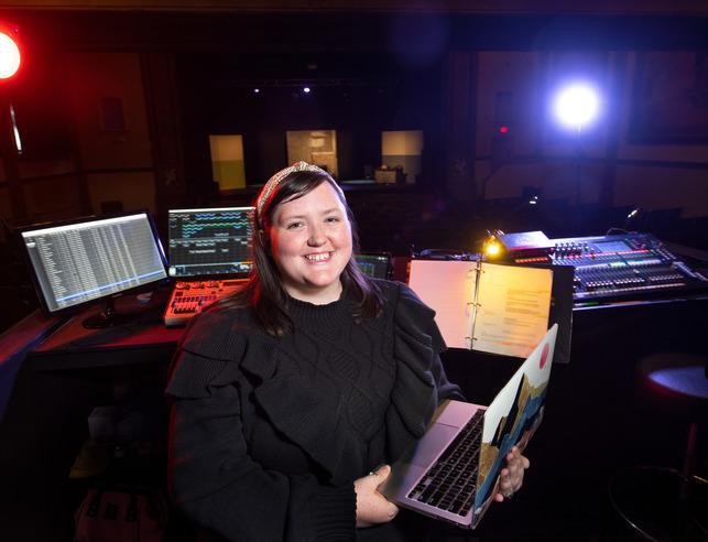A student backstage helping with tech