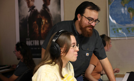 A faculty member and a student work on a piece of audio together