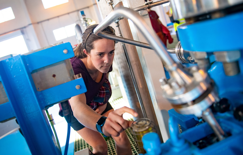 Student examining a pump