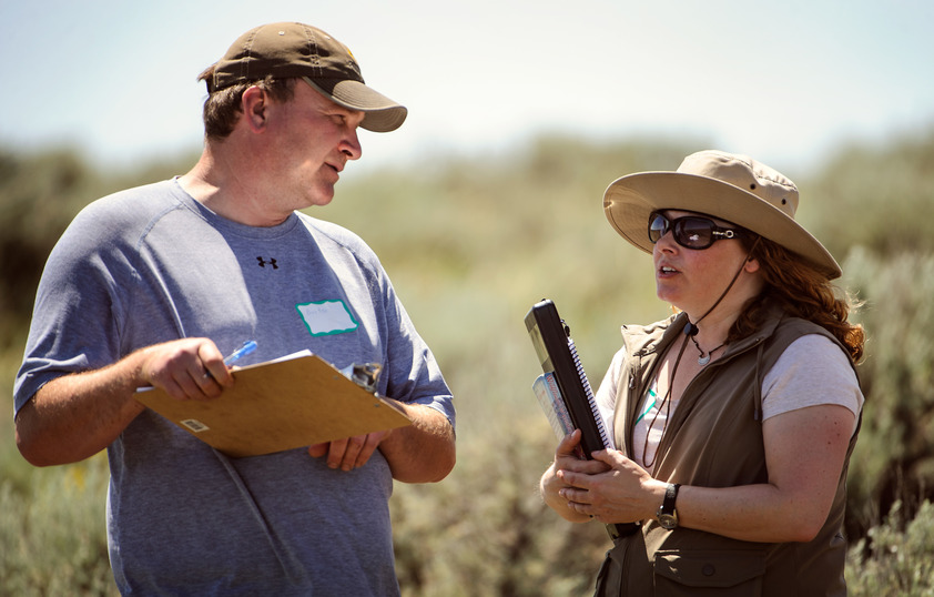 Professor and student in field