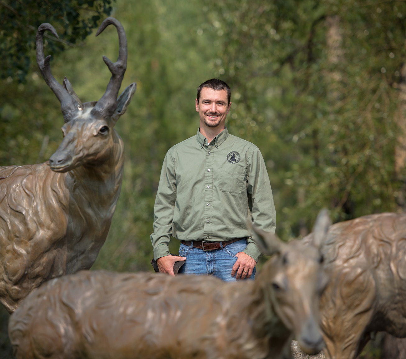 Alum posing with pronghorn statue