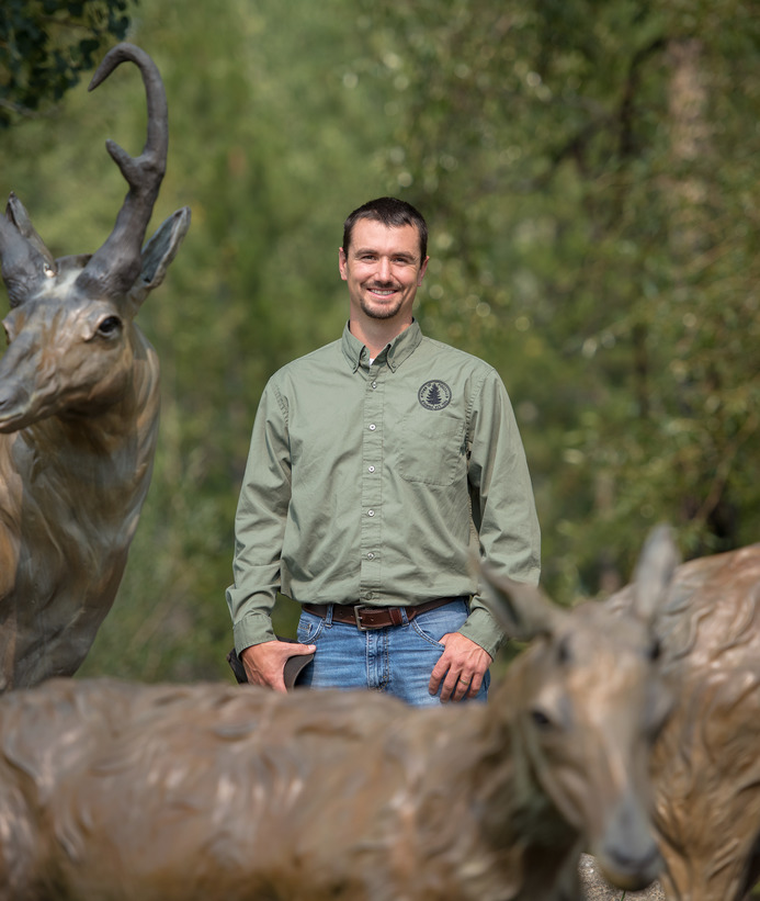 Alum posing with pronghorn statue