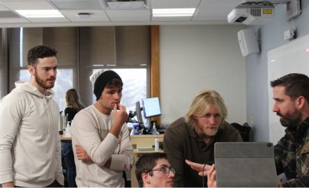 Students work together on a computer