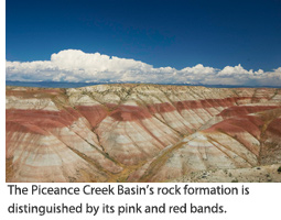 The Piceance Creek Basin’s rock formation is distinguished by its red and pink bands.