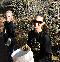 Two students working park cleanup