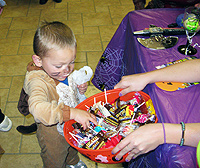 Child picking candy out of bowl
