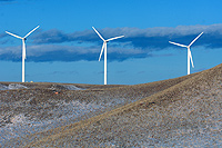 Three wind turbines on horizon