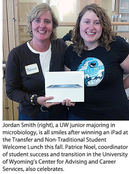 Jordan Smith (right), a UW junior majoring in microbiology, is all smiles after winning an iPad at the Transfer and Non-Traditional New Student Welcome Lunch this fall. Patrice Noel, coordinator of student success and transition in the University of Wyoming’s Center for Advising and Career Services, also celebrates.