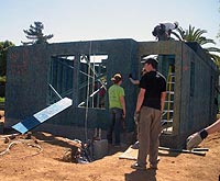 Two people constructing house