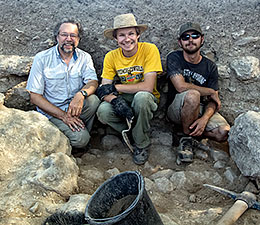 Three people at excavation